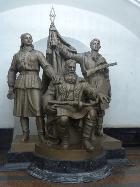 Three men carrying guns, holding the flag...